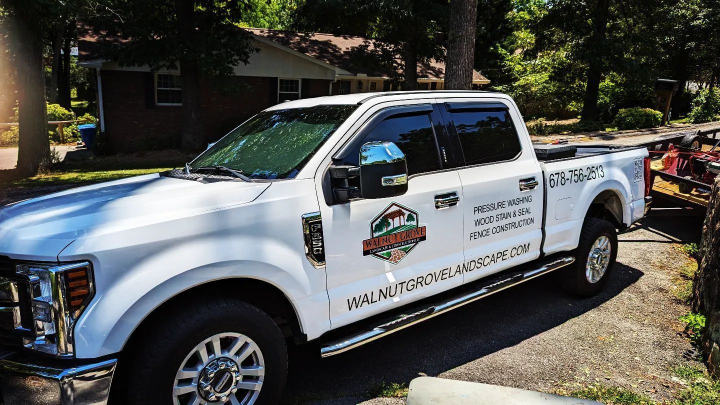 A white truck is parked in front of a house.