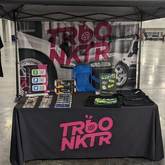 A table with a black table cloth that says trobo nktr