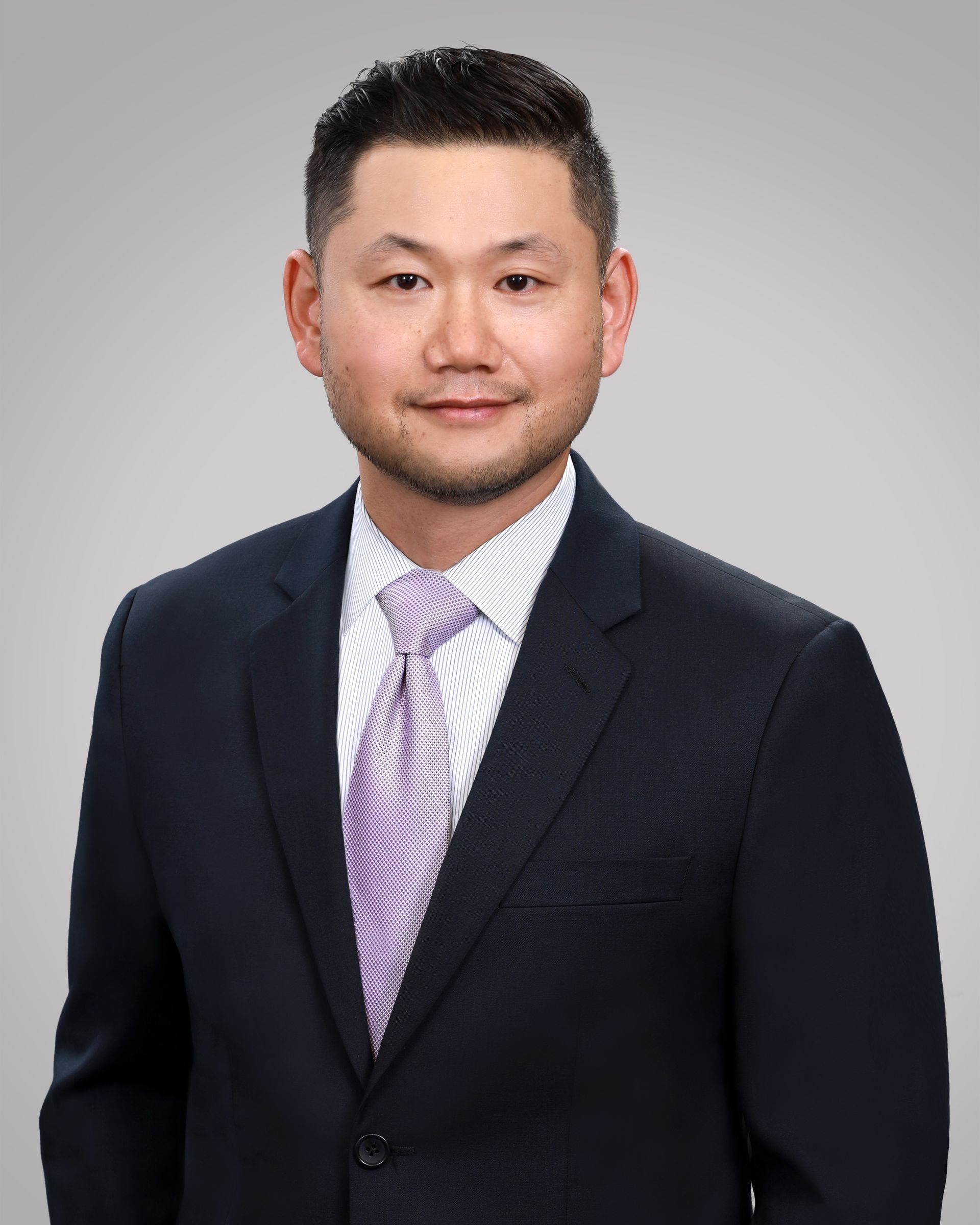 Aaron C. Lee looking at the camera, neutral expression, indoors.