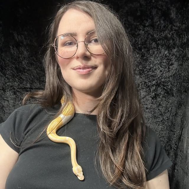 Arden Hart (she/her) is a trans rights activist and reptile enthusiast first and foremost. She grew up in a staunchly conservative town and her family was involved in a non-denominational charismatic church for much of her early life. Despite that upbringing—or perhaps because of it—she became aware of her trans identity from an early age. That was one of the most consequential forces that knocked over the first domino in her deconversion and laid the path to where she is today, a brazen atheist, skeptic, humanist, and defender of trans rights.