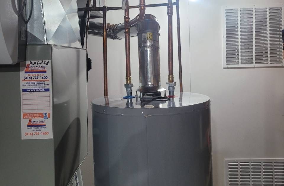 A water heater is sitting in a basement next to a furnace.