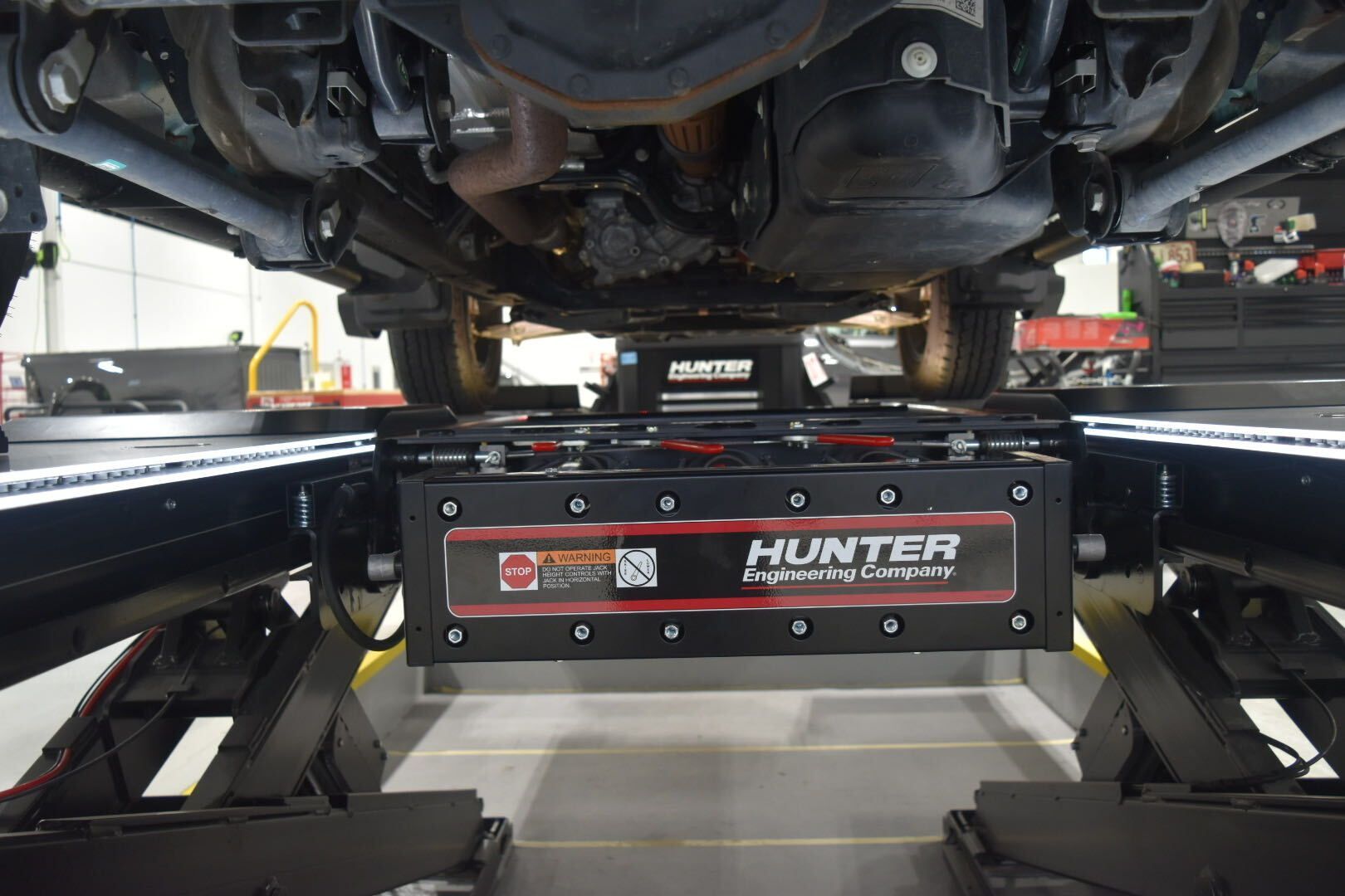 Car underside on a Hunter wheel alignment machine in an auto repair shop
