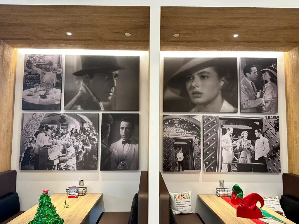 Two booths with film posters in a restaurant, decorated with Christmas ornaments.