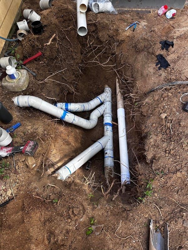 Pvc Pipe Network Consisting of Several White Pipes — Dunnrite Plumbing Services in Cannonvale, QLD