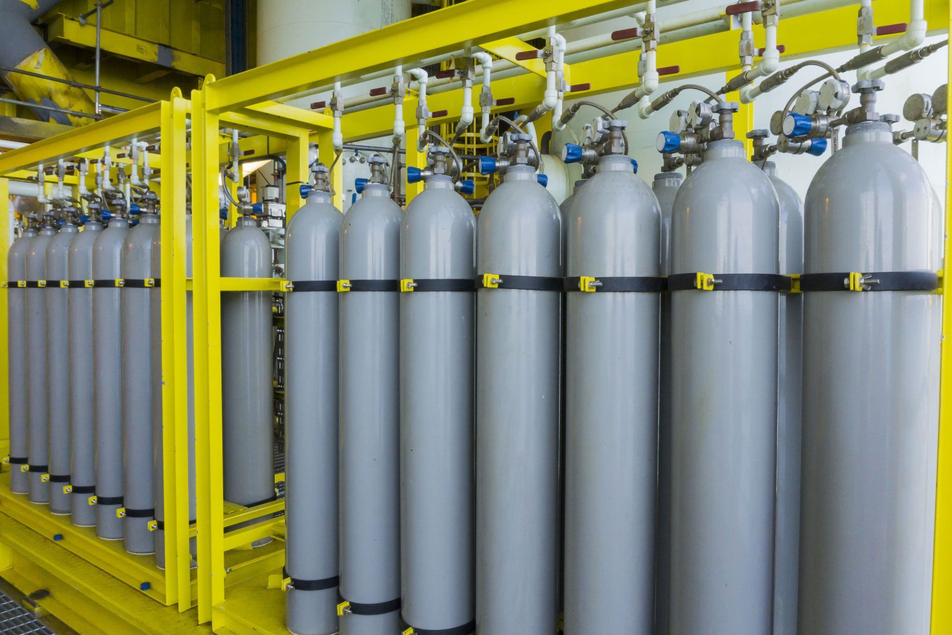 Rows of Silver Gas Cylinders Secured — Dunnrite Plumbing Services in Cannonvale, QLD