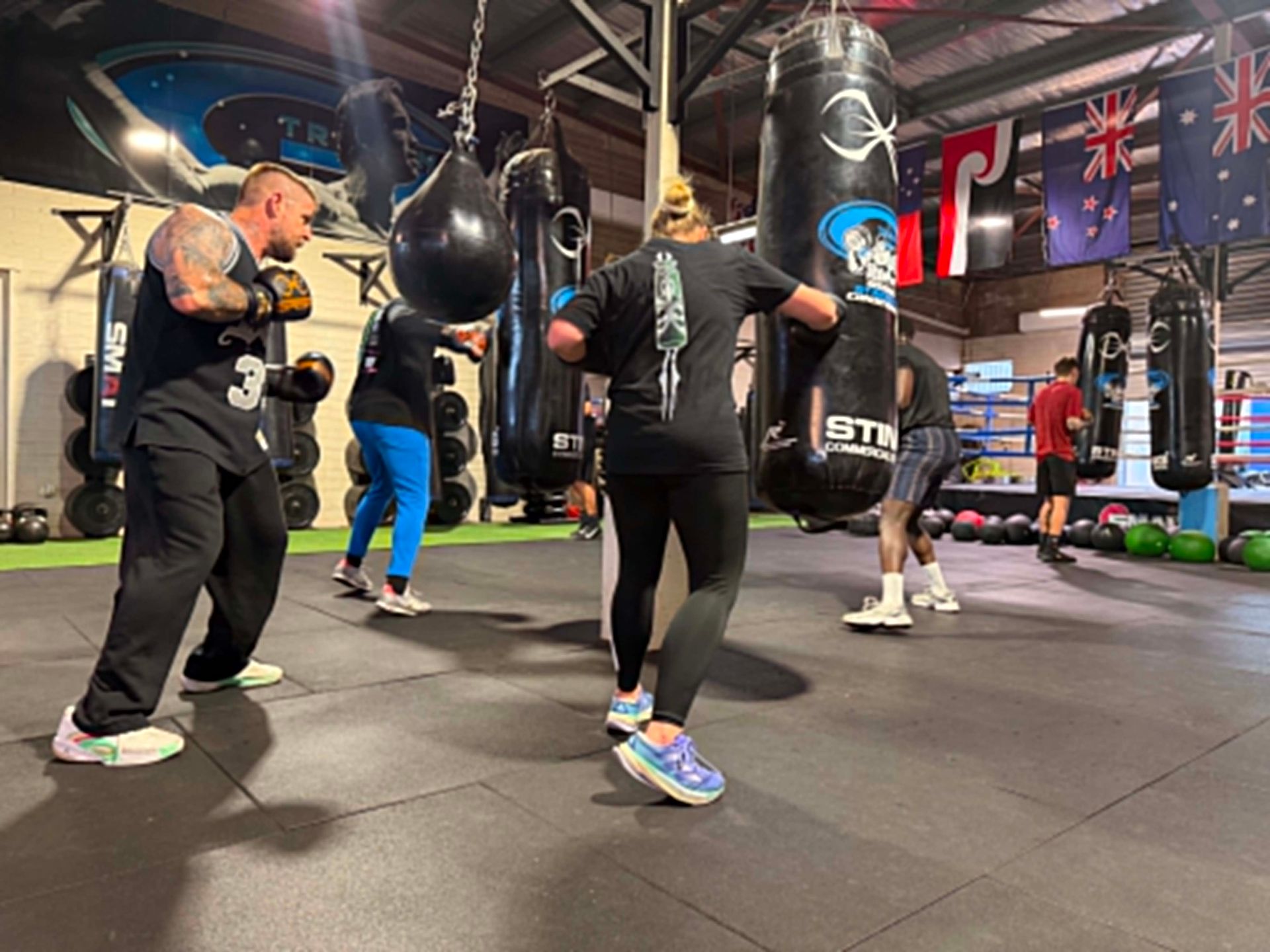 A group of people are boxing in a gym.