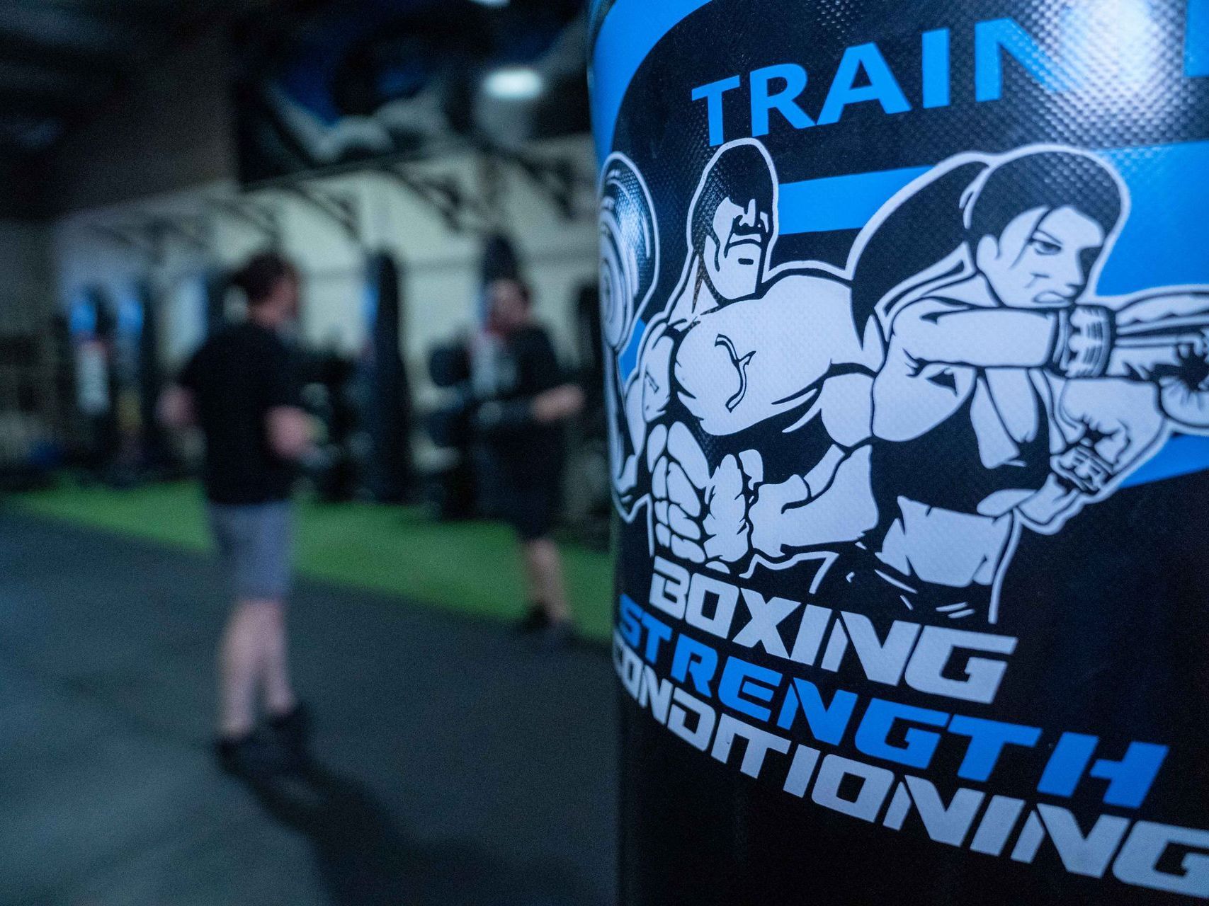 A boxing strength conditioning bag is in a gym