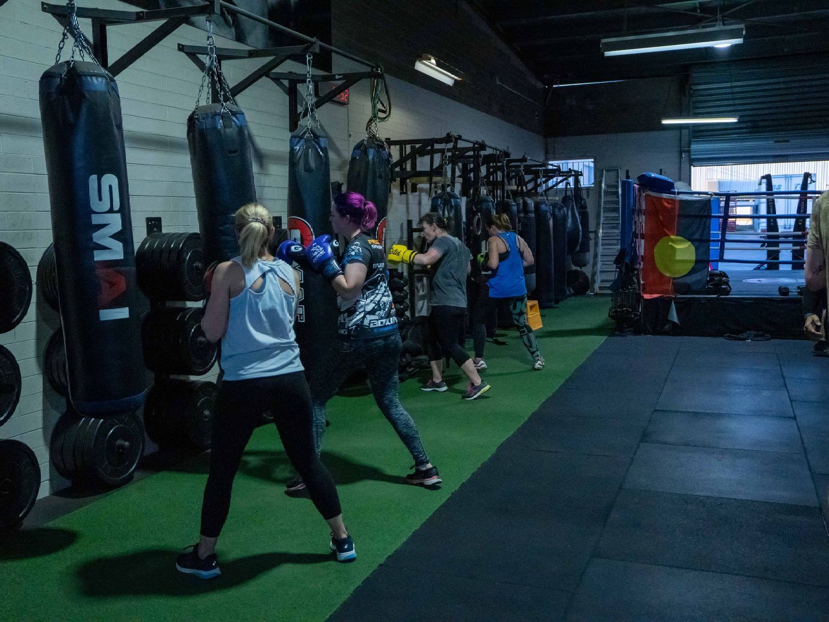 A group of people are boxing in a gym.