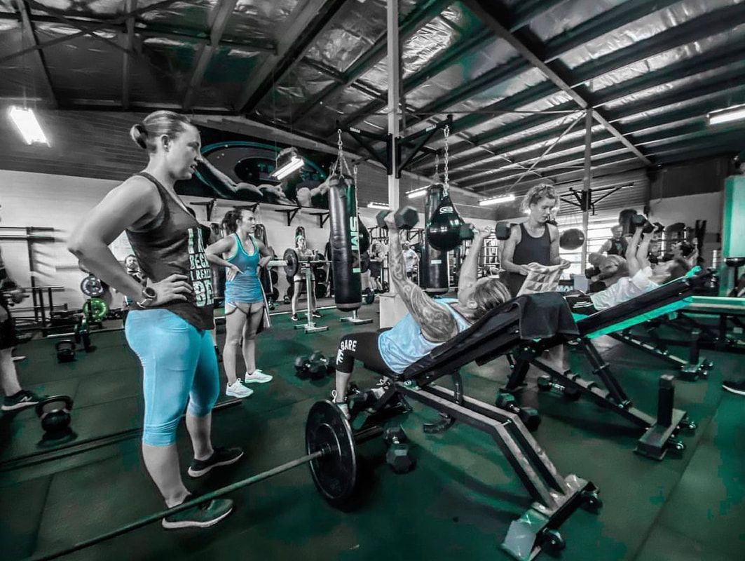 A group of people are working out in a gym.