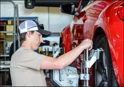 Mechanic Working With Wheel | Oneida Service Center