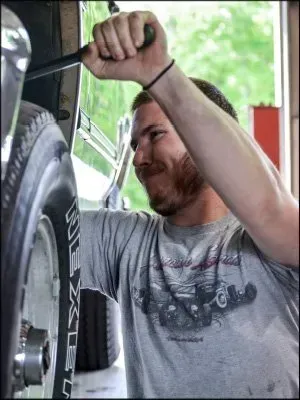 Mechanic Working With Wheel | Oneida Service Center