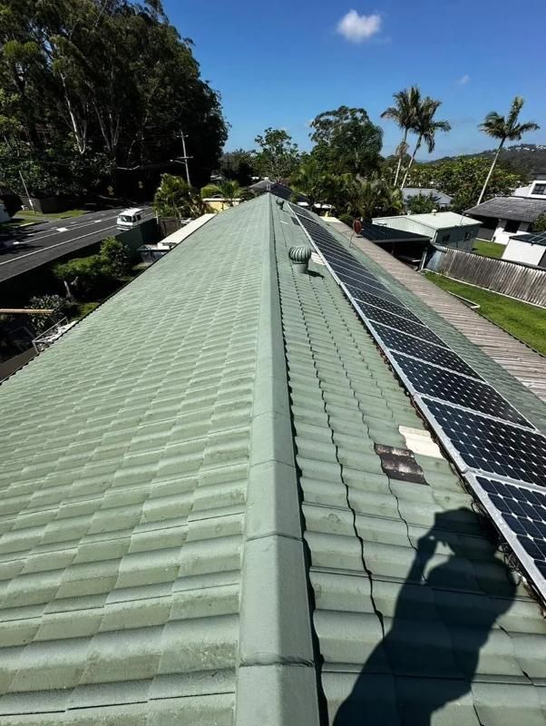 A Green Tiled Roof With Solar Panels On It — Clean Cartel Pressure Washing In Reedy Creek, QLD