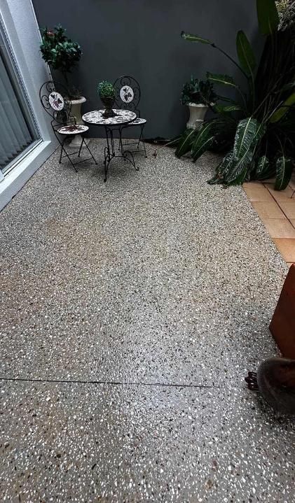 A Patio With A Table And Chairs And Plants On It — Clean Cartel Pressure Washing In Reedy Creek, QLD