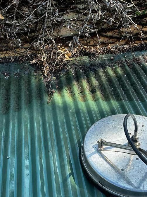 A Metal Object Is Sitting On Top Of A Green Roof — Clean Cartel Pressure Washing In Reedy Creek, QLD