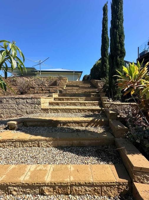 A Set Of Stone Stairs Leading Up To A House — Clean Cartel Pressure Washing In Burleigh, QLD