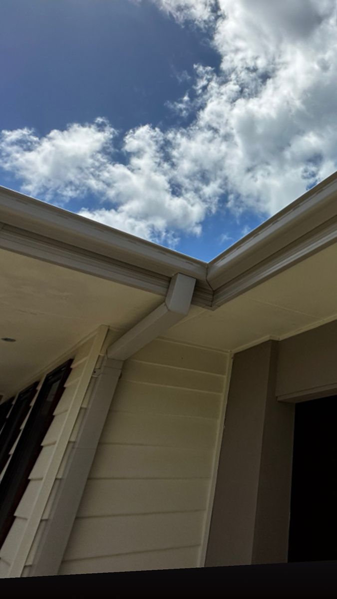 A Gutter On The Side Of A House With A Blue Sky In The Background — Clean Cartel Pressure Washing In Reedy Creek, QLD