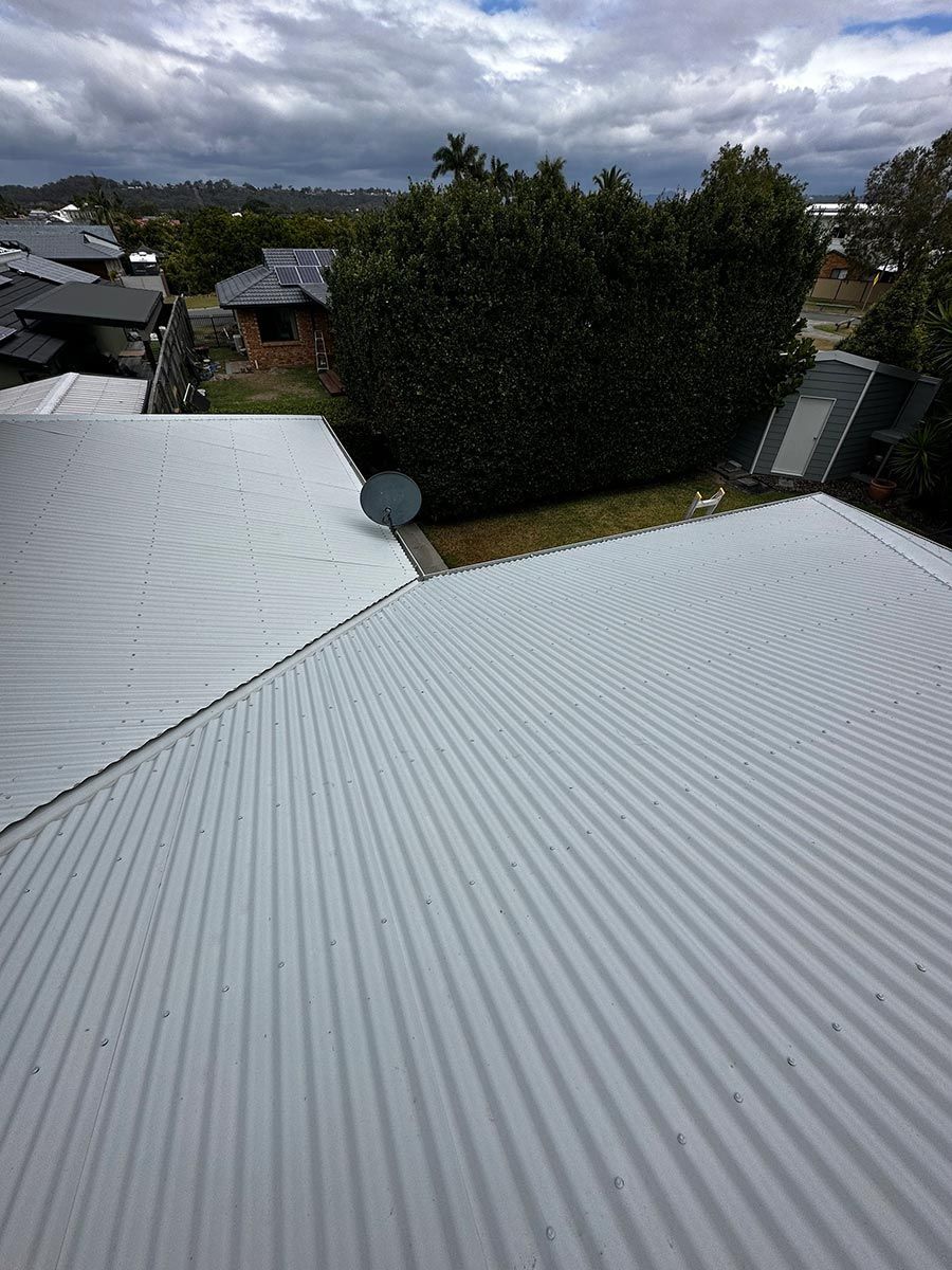 A White Corrugated Metal Roof With A Satellite Dish On It — Clean Cartel Pressure Washing In Mudgeeraba, QLD