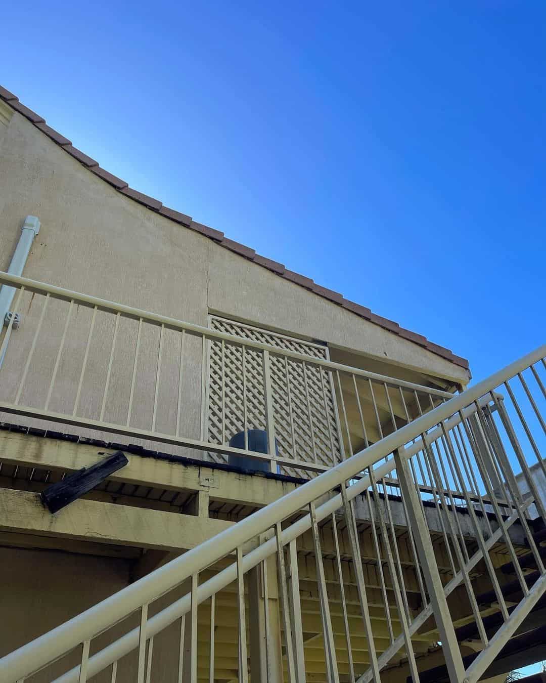 Looking Up At A Building With A Balcony And Stairs — Clean Cartel Pressure Washing In Reedy Creek, QLD