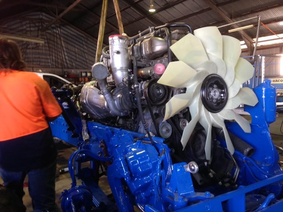 Man Fixing Part Of The Trucks — Towing Service In Narromine, NSW