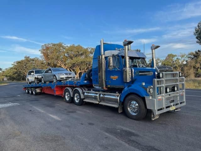 Big Tow Truck Transporting Two Cars — Towing Service In Coonabarabran, NSW