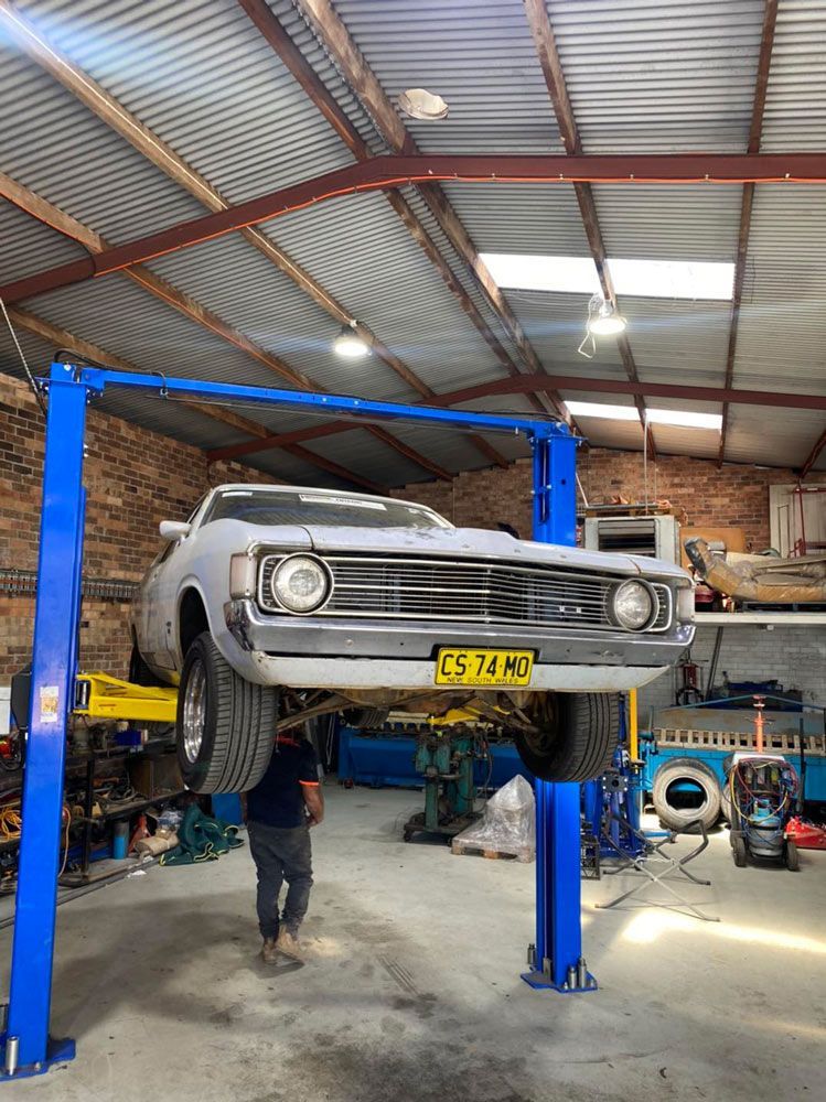 Car Raised On Car Lift — Towing Service In Coonabarabran, NSW