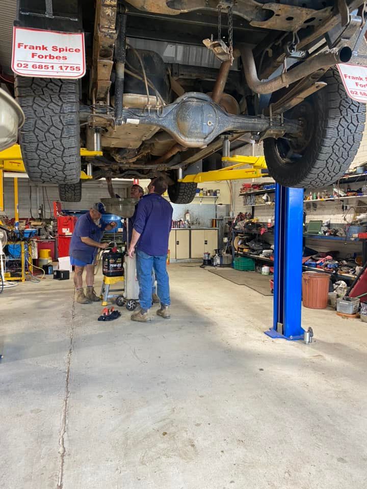 Three Man Repairing The Car On Car Lift — Towing Service In Coonabarabran, NSW