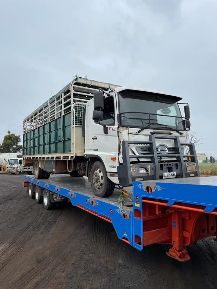 Truck Loaded Onto Blue Towing Truck — Towing Service In Coonabarabran, NSW