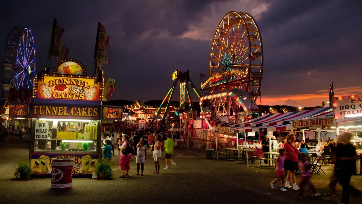 Ferris wheel and colorful fair rides illuminated at night during the 2025 Maryland State Fair in Timonium, Maryland.