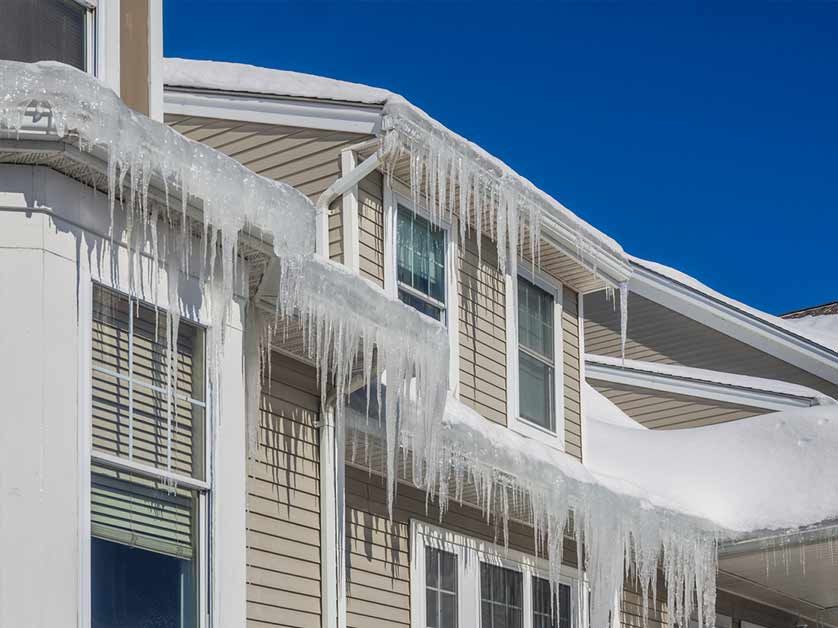 Ice dam and icicles building up on a roof