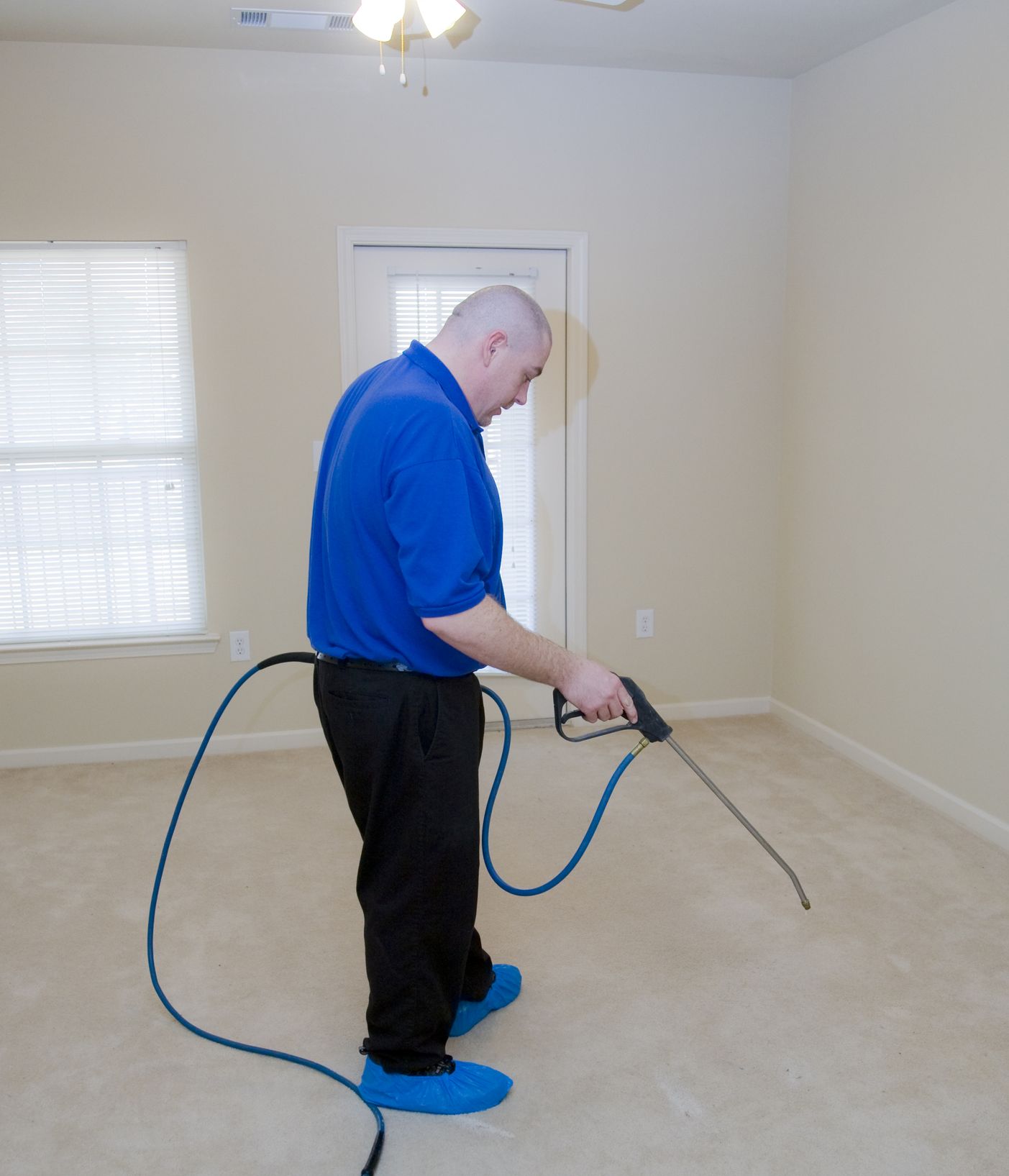 Worker Spraying Carpet