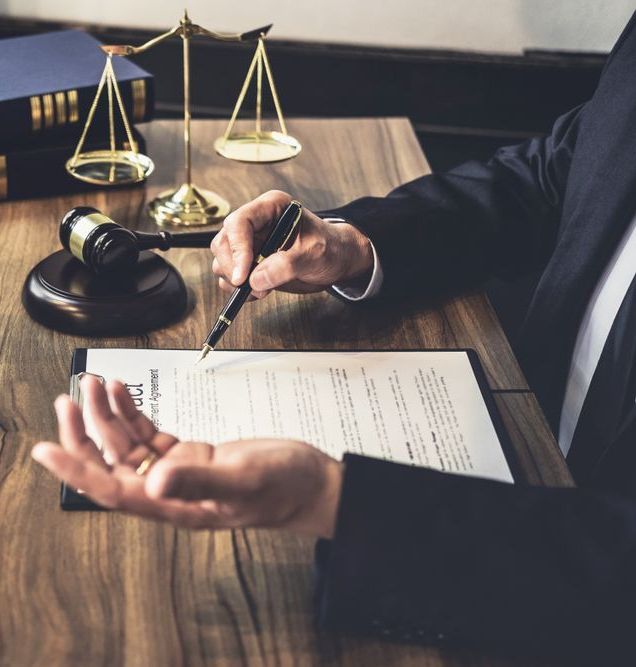 A Man Is Writing On A Piece Of Paper With A Pen — Charlestown Law Firm In Port Stephens, NSW