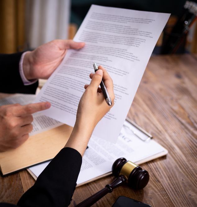 A Person Is Writing On A Piece Of Paper With A Pen — Charlestown Law Firm In Newcastle, NSW