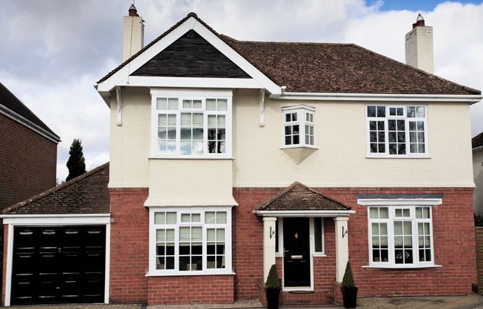 a house with a garage that has a black door