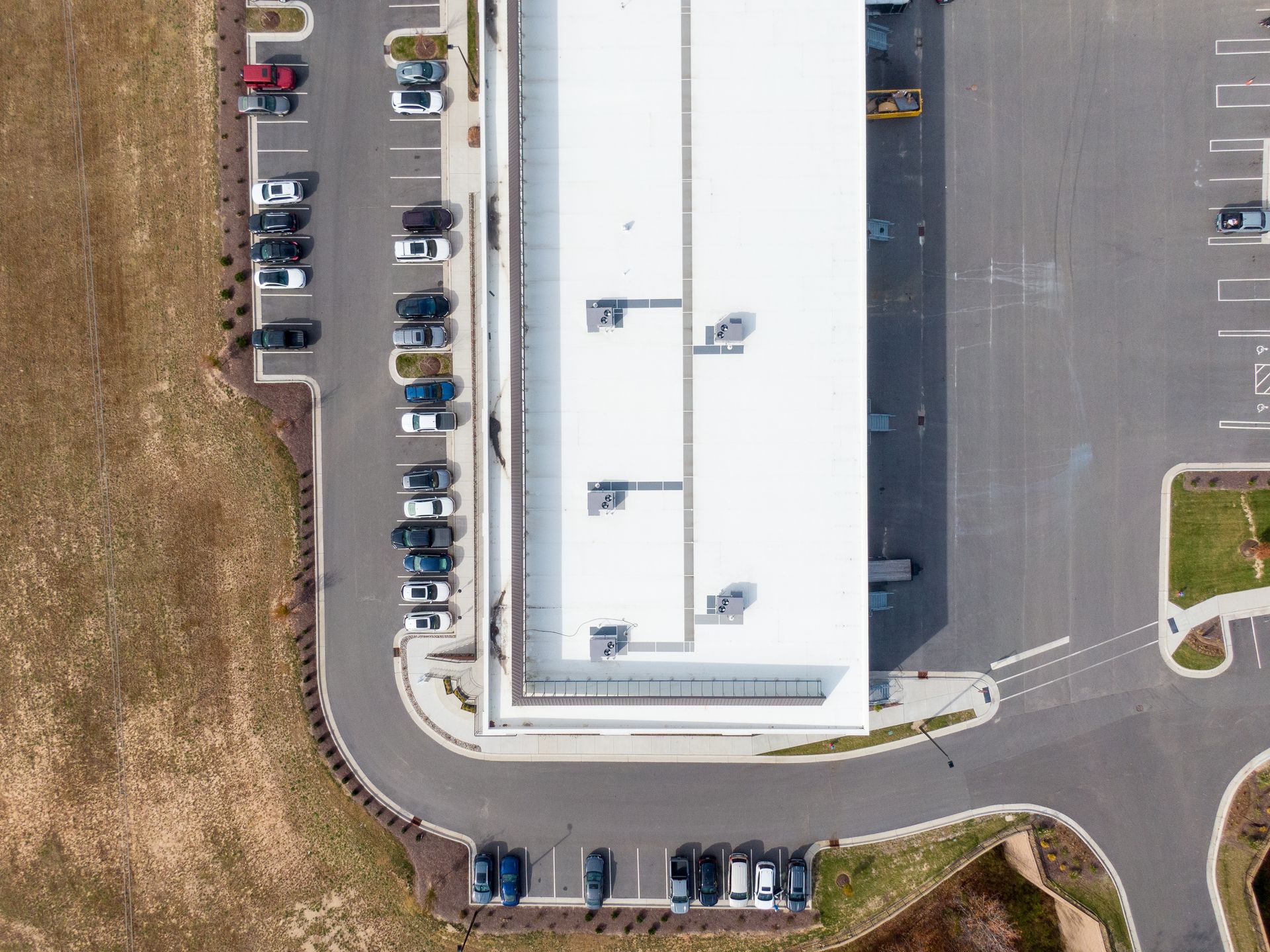 An aerial view of a building with cars parked in front of it