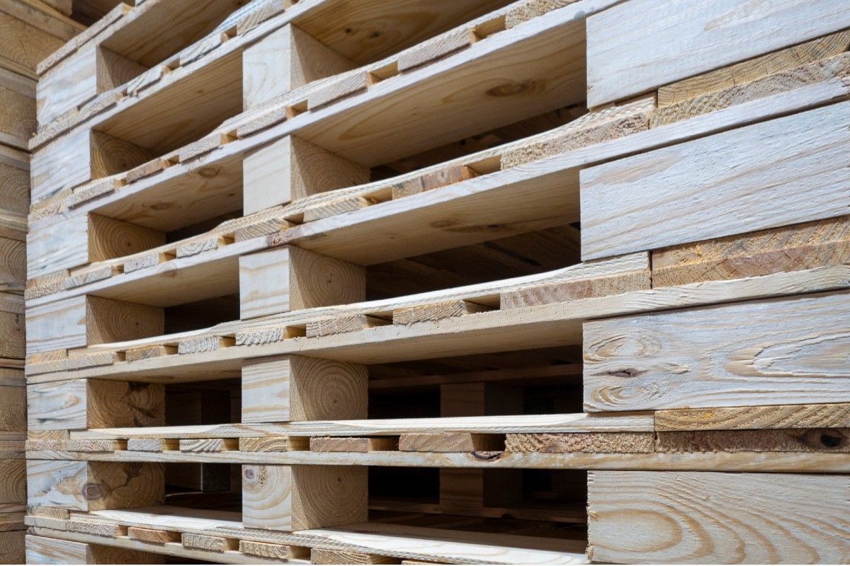 A stack of wooden pallets stacked on top of each other. A stack of wooden pallets stacked on top of each other.