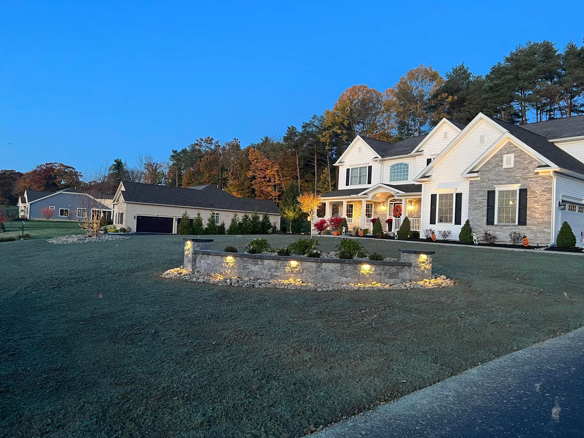 A large house with a fountain in front of it