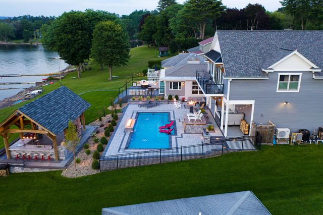 An aerial view of a house with a swimming pool and a gazebo.