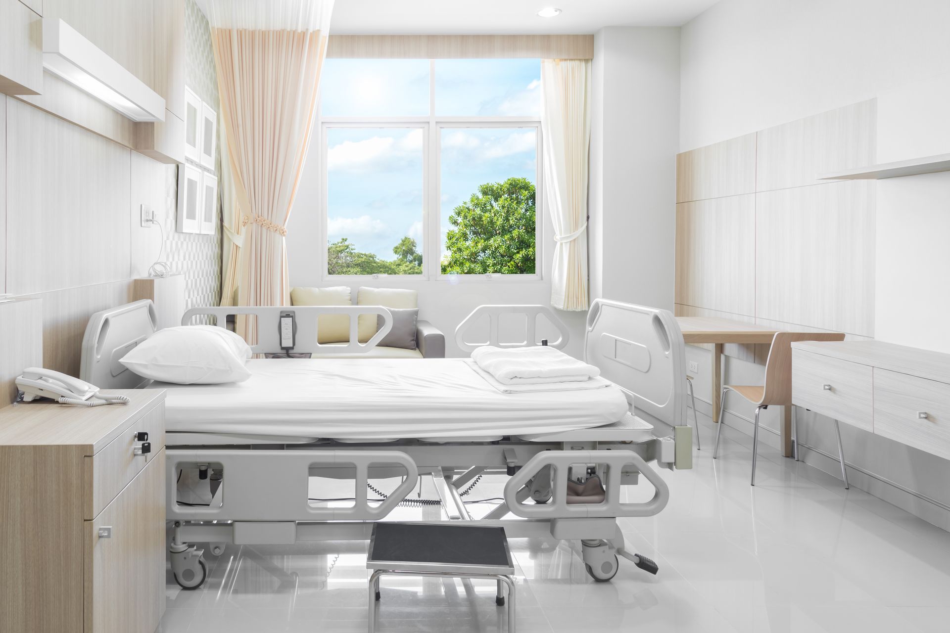 A hospital room with a bed and a window.