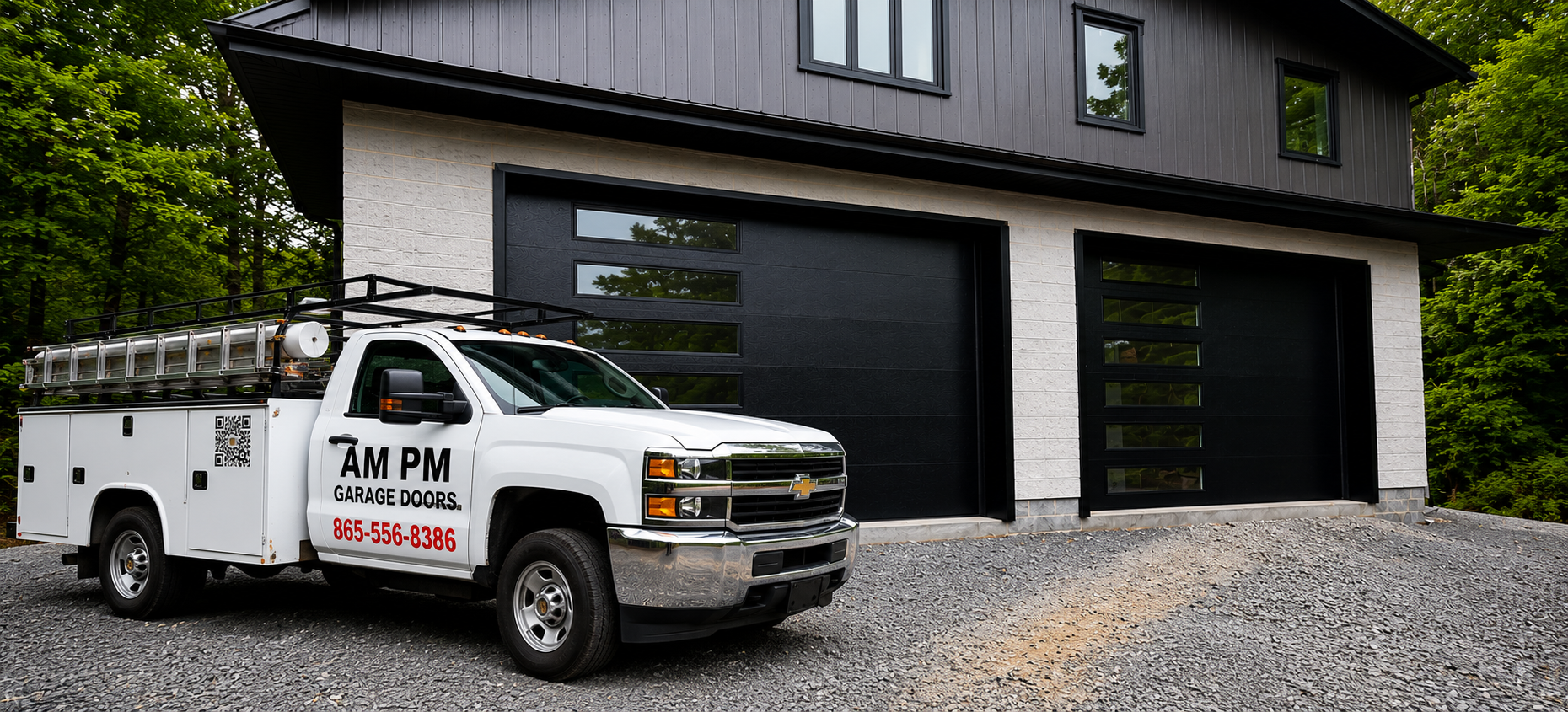 White utility truck parked in front of a modern gray house with two black garage doors and gravel driveway