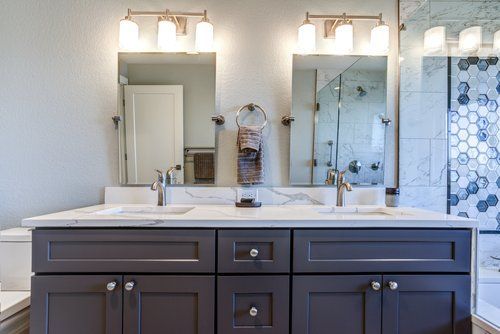A bathroom with two sinks and two mirrors.
