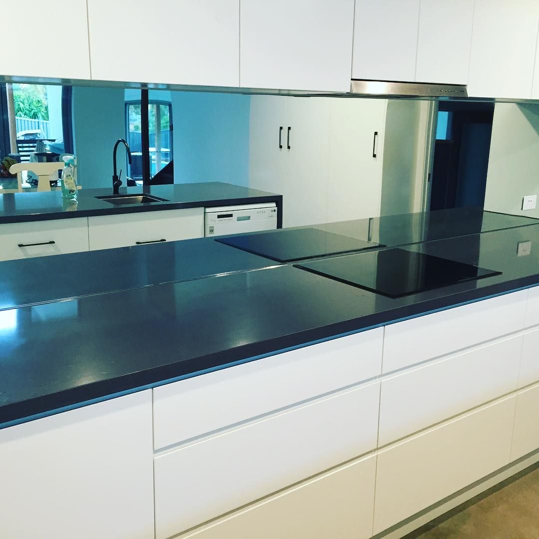 A Kitchen With Black Counter Tops and White Cabinets — Swift Glass & Aluminium In Nambucca Heads, NSW