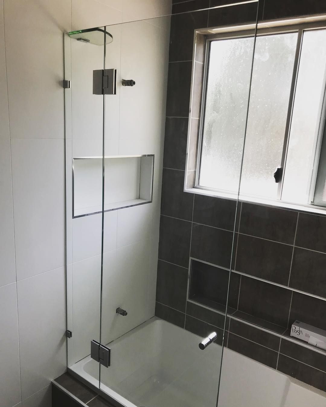 A Bathroom With a Bathtub and a Window With a Glass Shower Door — Swift Glass & Aluminium In Nambucca Heads, NSW