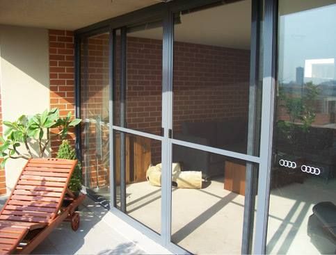 A Sliding Glass Door With an Audi Logo on It — Swift Glass & Aluminium In Valla, NSW
