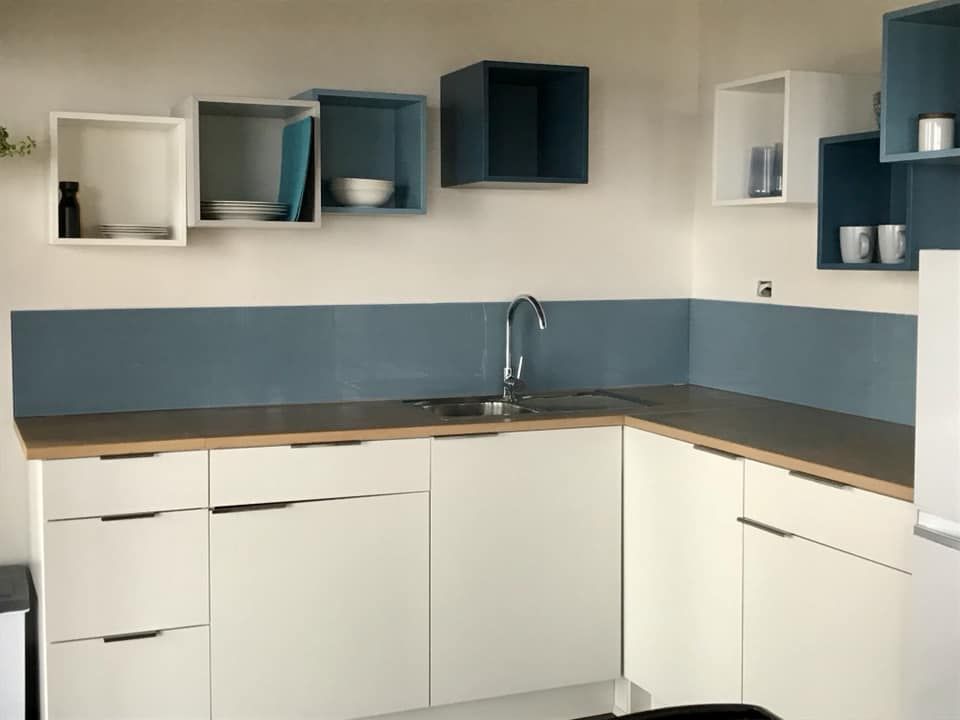 A Kitchen With White Cabinets and a Sink β Swift Glass & Aluminium In Woolgoolga, NSW