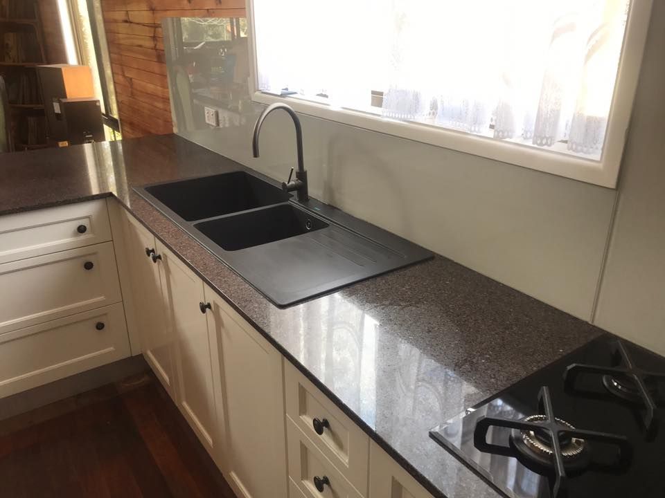 A Kitchen With Two Sinks and a Stove Top Oven — Swift Glass & Aluminium In Bellingen, NSW