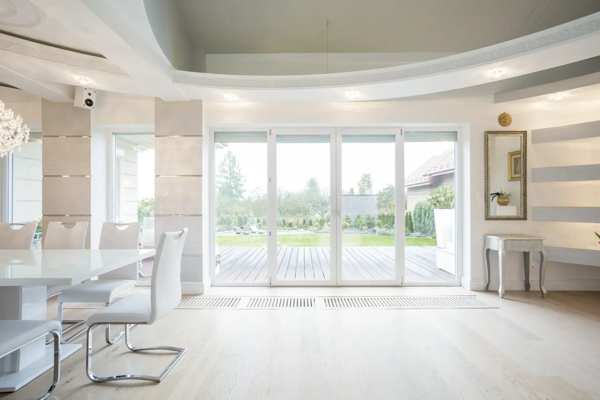 A Dining Room With a Table and Chairs and Sliding Glass Doors — Swift Glass & Aluminium In Woolgoolga, NSW