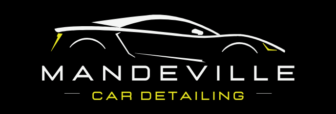 A logo for mandeville car detailing with a yellow car on it.