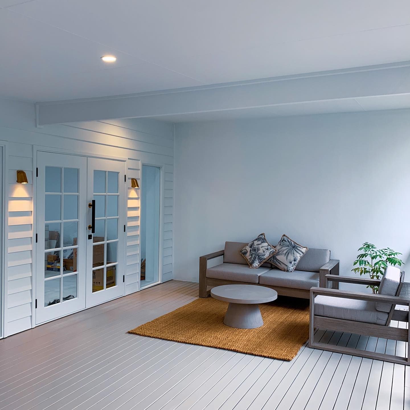 A Bright, White Porch With a Gray Sofa, Chair, Round Concrete Table — All Coast Painting in Tweed Heads South, NSW