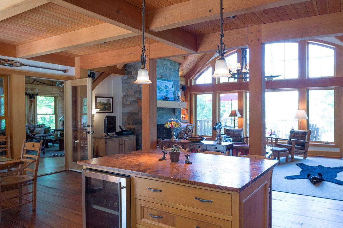 View of a familycottage main floor with kitchen island, bar fridge, open concept.