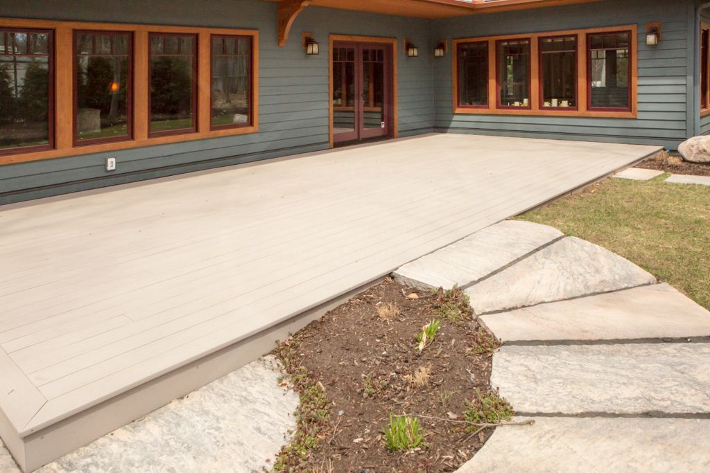 Wide, double entry doors to a rear patio made with concrete for smooth wheelchair access.